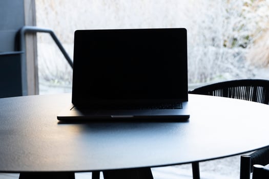 laptop on a round table with an outdoor background. Mockup design, for business, remote work, or modern workspace themes. photo