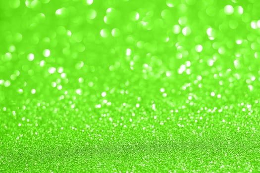 Green glitter background with a bright light photo