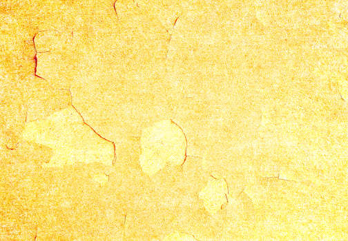 A yellow painted wall with a few cracks photo