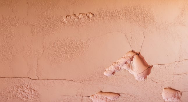 Rough peach stucco wall texture with depth photo