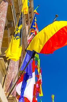 European countries flags on facade of Antwerp City Hall Stadhuis Antwerpen building in Antwerp city historical centre, vertical view, Flemish Region photo
