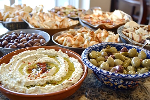 Hummus, pita bread and olives comprising a delicious mediterranean mezze platter photo