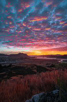 A sunset over a hill with a view of the ocean photo