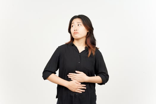 Stomachache gesture think about food, hungry concept of Beautiful Asian Woman Isolated On White photo