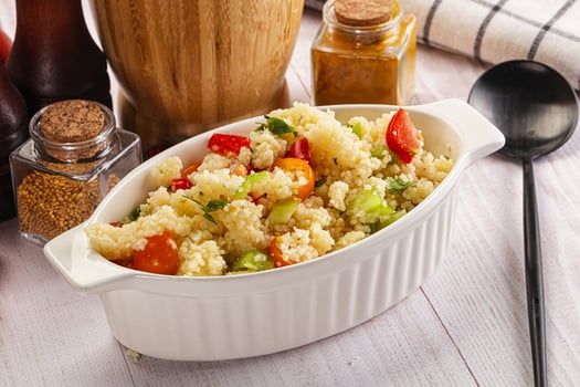 A white bowl filled with a salad on a table photo