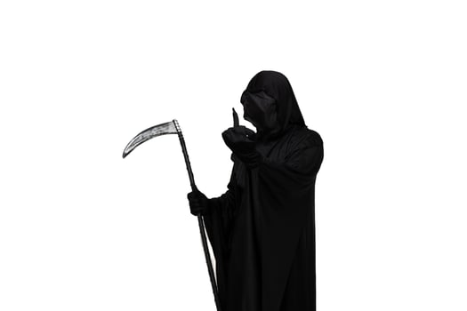 Grim reaper in Halloween costume holding scythe and making rude gesture towards camera photo