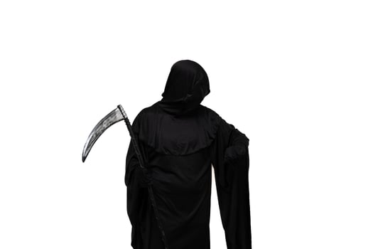 Grim reaper in Halloween costume holding scythe and impatiently checking wristwatch photo