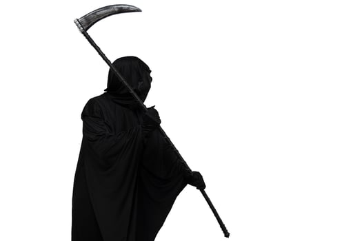 Grim reaper in Halloween costume threatening with scythe towards copyspace white background photo