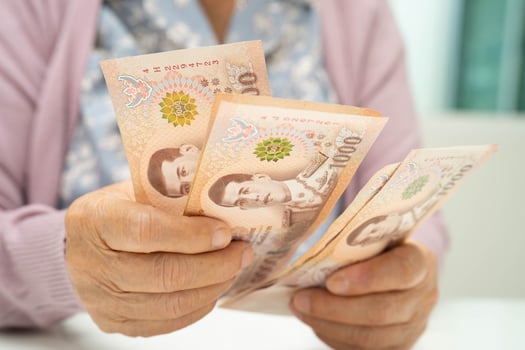 Retired elderly woman counting coins money and worry about monthly expenses and treatment fee payment. photo