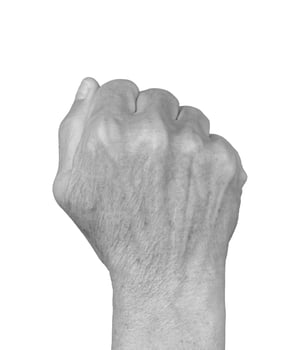 Clenched fist gesture. Senior woman s wrinkled hand shown from the dorsal view, veins visible, photo