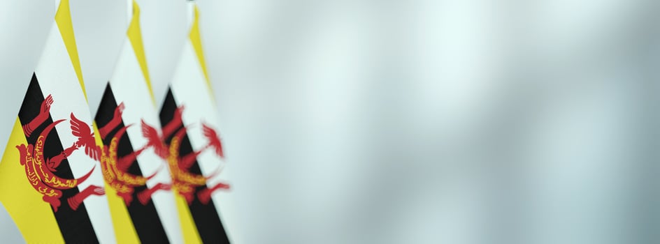Brunei table flags in the office, banner background with space for text photo