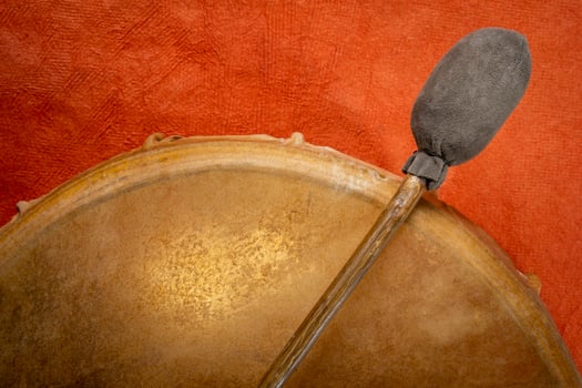 backlit, handmade, native American style, shaman frame drum covered by goat skin with a beater photo