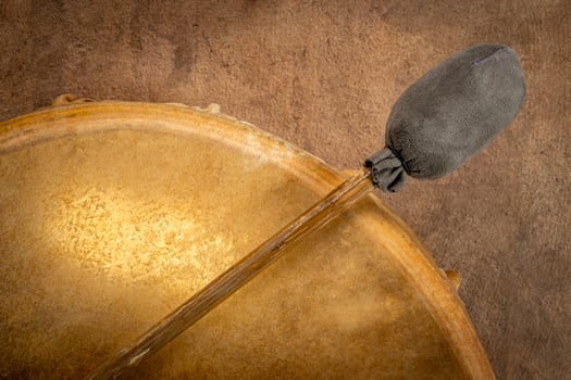 backlit, handmade, native American style, shaman frame drum covered by goat skin with a beater photo