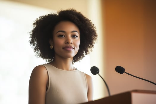 a woman is giving a speech at a podium photo