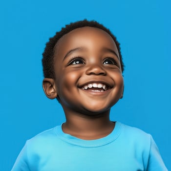 portrait of a smiling black child on a blue background photo