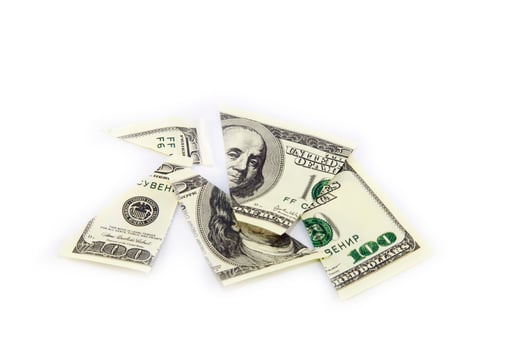 A broken dollar bill on a white background photo