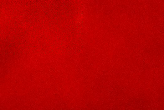 Red suede leather macro photo as background material for designers.