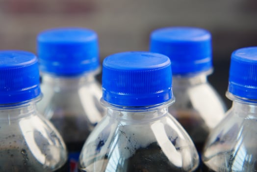 plastic bottles of soft drink on table photo