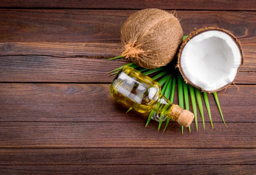 Coconut oil and coconut oil on wooden background photo