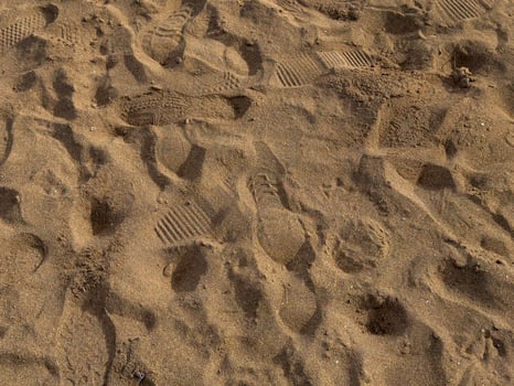 Footprints and patterns in sandy terrain photo