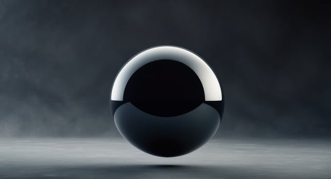Large black sphere is in the middle of a dark background photo