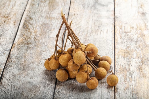 A bunch of kiwi fruit on a wooden table photo