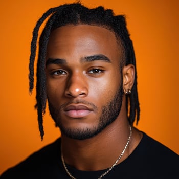 Confident young man with braided hair and orange background photo