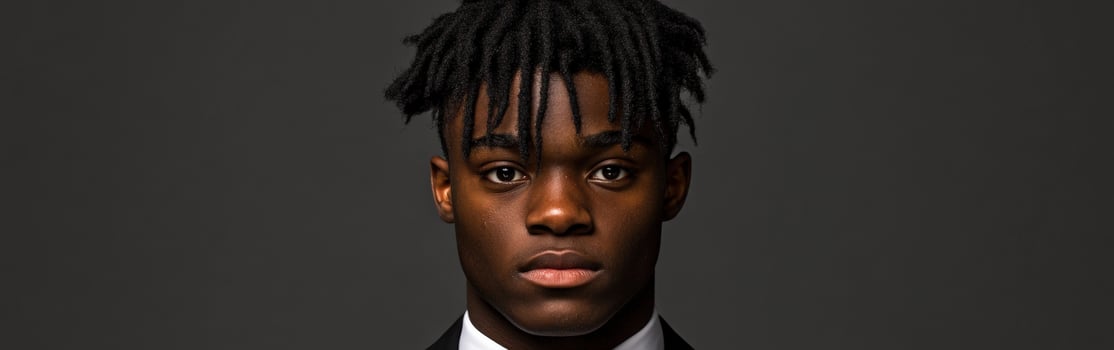Confident young man dressed in formal attire with styled hair photo