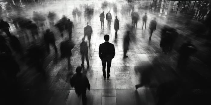 A lone figure stands out in a blurred crowd of the city photo