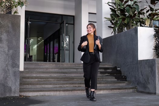 Confident Businesswoman Walking and Talking on Phone in Urban Cityscape photo