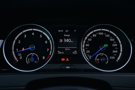 Close up view of a car's instrument panel showing the speedometer tachometer and fuel gauge photo