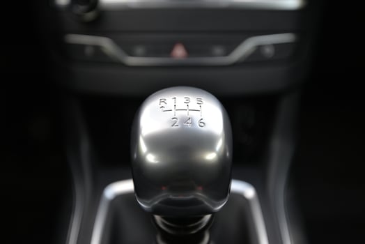 Close up of a silver metallic manual gear stick in a car's interior photo
