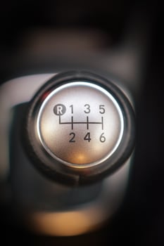 Close up of a six speed manual gear stick in a vehicle The metallic shift knob displays the gear positions clearly photo