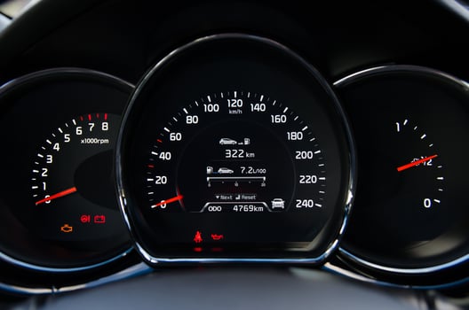 Close up view of a car's instrument panel showing speedometer tachometer and fuel gauge photo