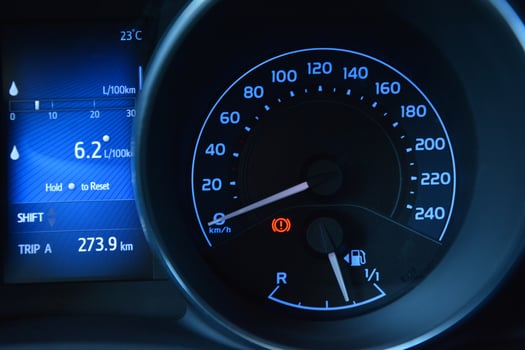 Car dashboard showing speed fuel level and trip information photo