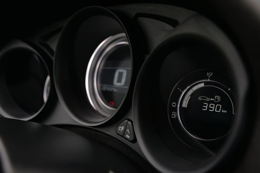 Close up of a car's dashboard displaying fuel level and mileage photo