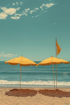 Two yellow umbrellas provide shade on a serene beach under a bright blue sky. photo