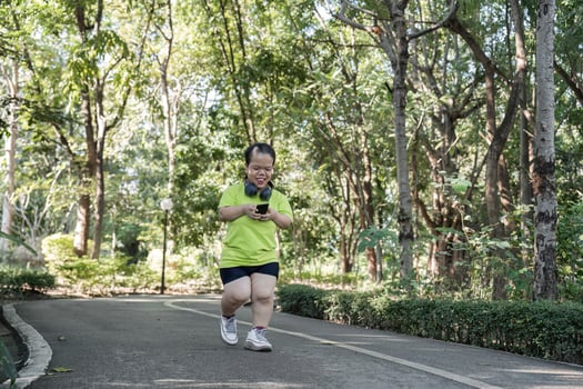 Empowered Young Woman with Disability Jogging in Park for Fitness and Wellbeing photo