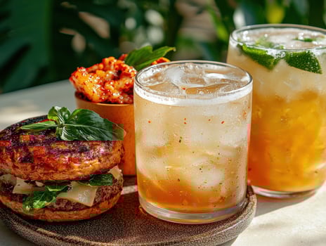 Delicious grilled burger with kimchi and refreshing summer drinks photo