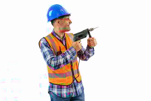 Construction worker drilling a hole in the wall, wearing orange reflective vest and safety helmet photo
