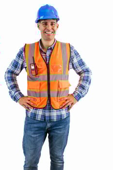 vertical Construction worker with hands on hips wearing orange vest and safety helmet photo