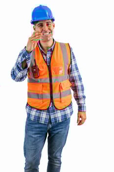 vertical Construction worker putting on safety glasses wearing orange vest and hard hat photo