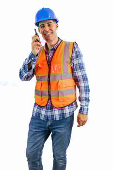 vertical Construction worker communicating via walkie-talkie wearing orange vest and safety helmet photo