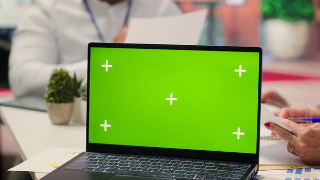 Old couple exploring financial retirement options with advisor next to green screen on laptop in modern office. Senior people receive counseling from broker about a retirement plan. Camera A. photo