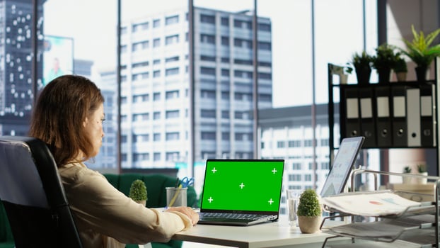 Woman chief executive officer working with mockup copy space screen on device, developing a project for enterprise growth and objectives achievement. Female director with determination. Camera B. photo