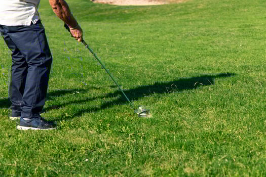 senior golfer unrecognizable striking the ball during tournament photo