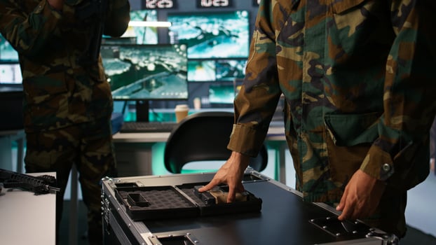 Military officer checking handguns in command room, ensuring bullets and supplies are working properly. Close up of soldier holding pistol, managing combat load equipment, camera B photo