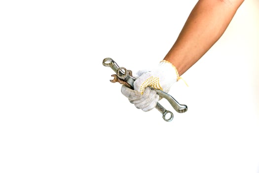 a person holding a wrench in their hand photo