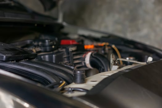 a close up of a car engine with the hood open photo