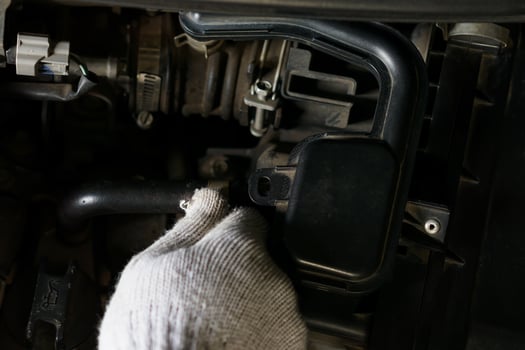 A mechanic inspecting the engine components of a vehicle for maintenance. photo